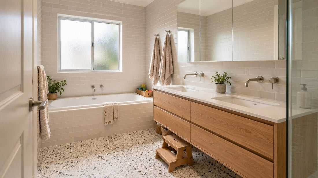 Family bathroom with mixed terrazzo look floor, bone subway walls, inset bath and oak vanity