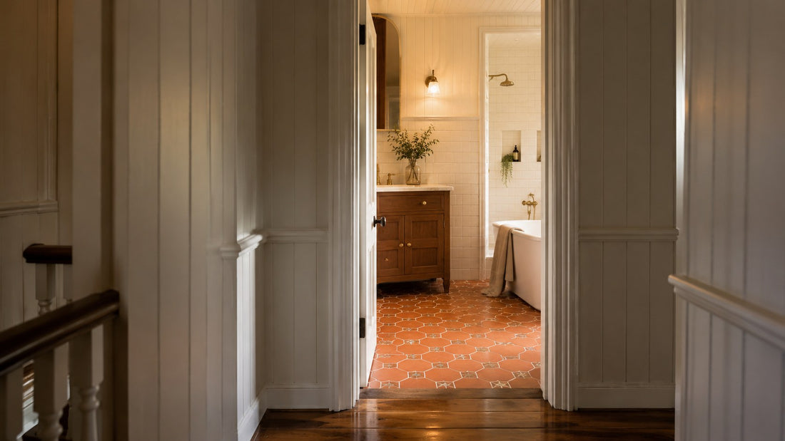View from a Queenslander hallway into a renovated bathroom with terracotta hexagon floor