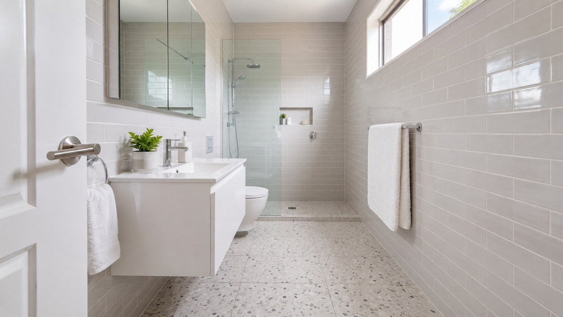 Compact apartment bathroom with white terrazzo floor and gloss subway walls
